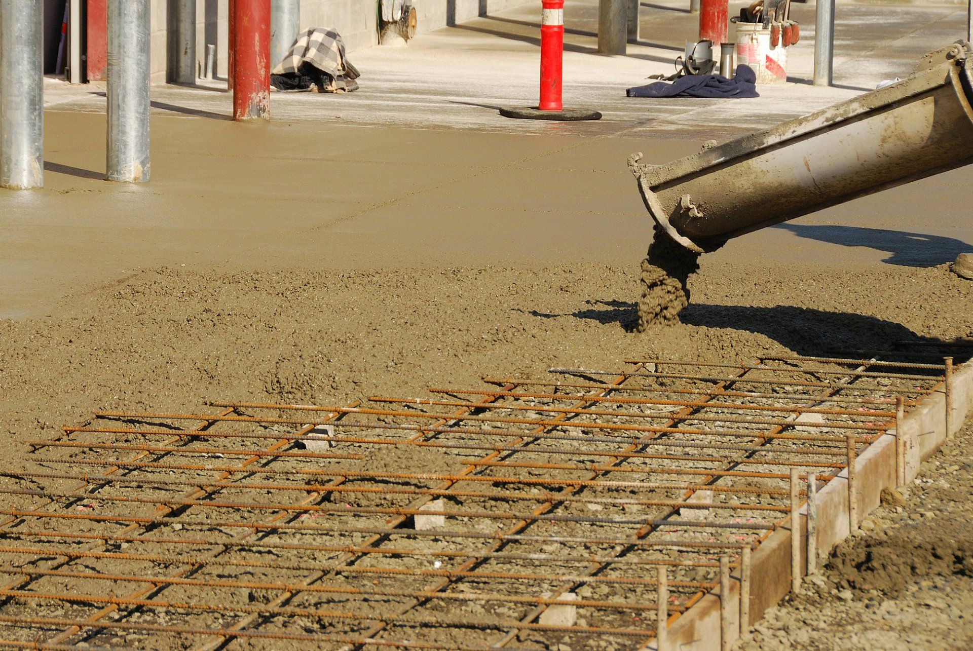 a specialized machine in operation to pour concrete mix into the frame