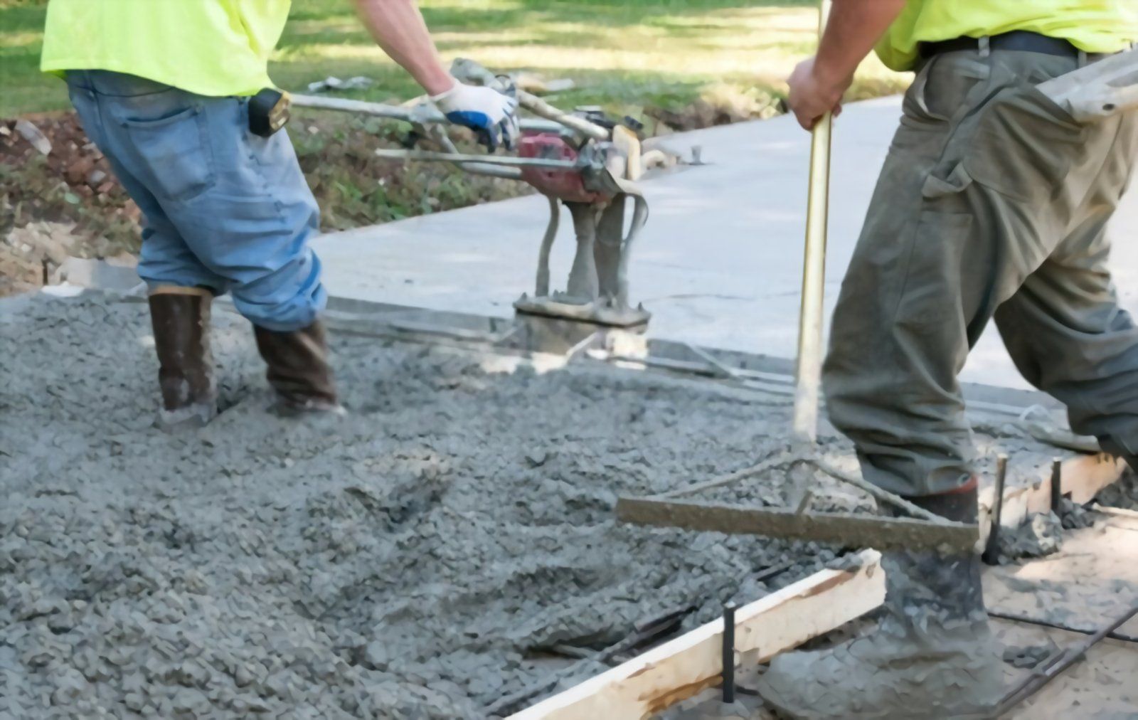 Local contractor using levelling tools to create a smooth surface