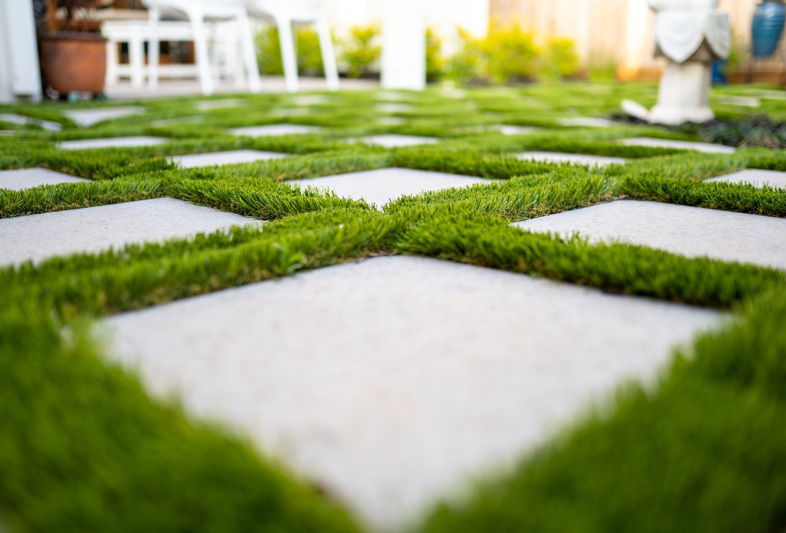 artificial grass installed between concrete squares to make a unique driveway in Palm City, FL