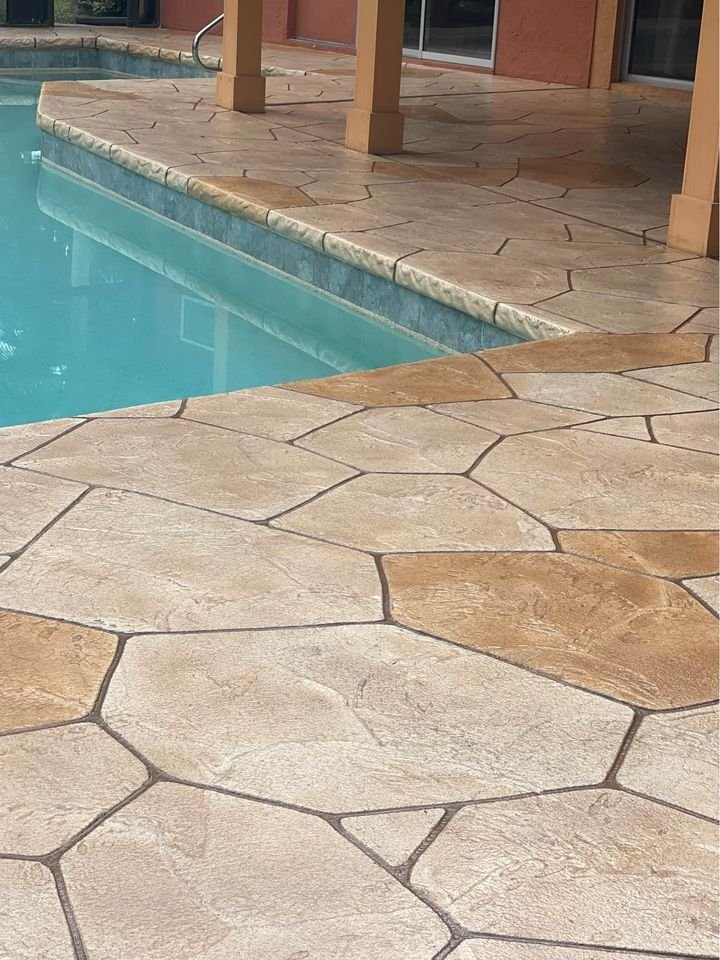 Palm Beach Stamped Concrete contractor leveling the surface of this newly restored pool deck